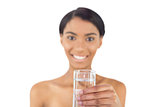 Cheerful attractive model holding glass of water