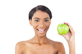 Cheerful attractive model holding green apple