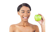 Smiling attractive model holding green apple