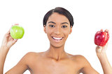 Smiling attractive model holding apples in both hands