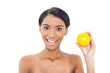 Smiling attractive model holding orange