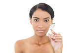 Peaceful natural model holding eyelash curler