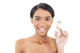 Smiling natural model holding eyelash curler