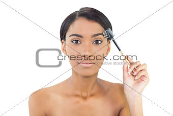 Gorgeous natural model using eyebrow brush