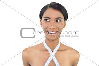 Smiling natural model with measuring tape around her neck