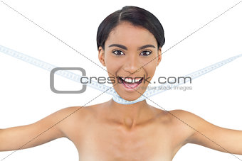 Cheerful natural model with measuring tape around her neck