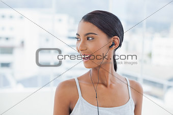 Smiling pretty model listening to music