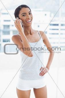 Cheerful sporty model on the phone
