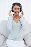 Smiling attractive woman listening to music