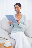 Cheerful attractive woman using her tablet computer