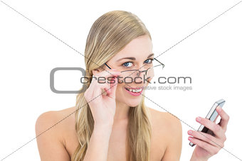 Charming young blonde woman holding a mobile phone
