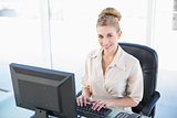 Attractive young blonde businesswoman using a computer