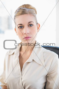 Stylish young blonde businesswoman looking at camera