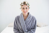 Pretty relaxed blonde woman in hair curlers posing