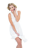 Amused fashion blonde model making a phone call