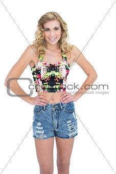Pleased retro blonde model posing with hands on the hips