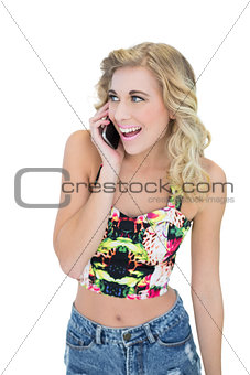 Joyful retro blonde model calling with her mobile phone