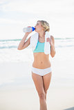 Peaceful blonde woman in sportswear drinking water
