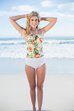 Pleased blonde model in swimsuit posing looking at camera