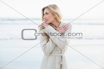 Thoughtful blonde woman in wool cardigan looking away