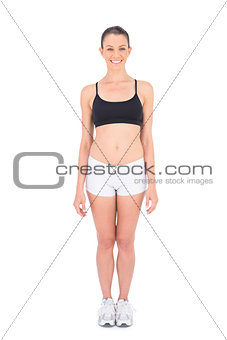 Fit woman wearing sportswear smiling at camera
