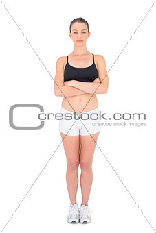 Serious woman in sportswear crossing arms