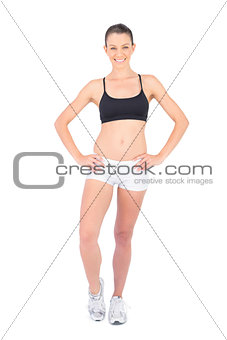Happy woman in sportswear stretching her ankle