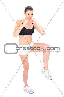 Serious woman in sportswear boxing