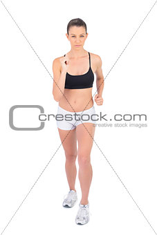Serious woman in sportswear preparing for start