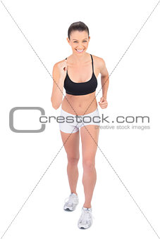 Smiling woman in sportswear preparing for race