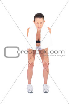 Tired fit model in sportswear holding sport towel