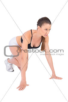 Serious woman in sportswear preparing for race