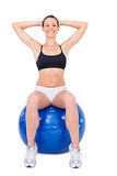 Happy fit woman working out with exercise ball