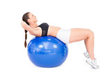 Smiling fit woman working out with exercise ball