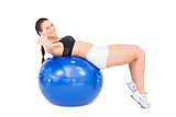 Sporty woman working out with exercise ball giving thumb up to camera