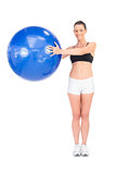 Happy fit woman working out using exercise ball