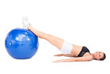 Smiling sporty woman working out with blue exercise ball