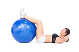 Fit woman developing her abs using exercise ball