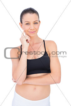 Thoughtful woman in sportswear looking at camera