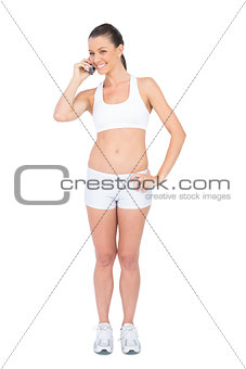 Cheerful woman in sportswear on the phone