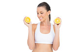 Fit woman holding slices of orange