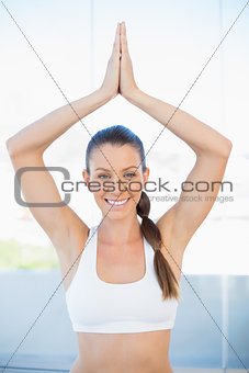 Smiling sporty woman sitting in yoga position