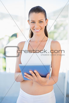 Attractive woman in sportswear using tablet