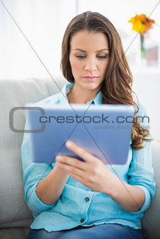 Serious woman using tablet