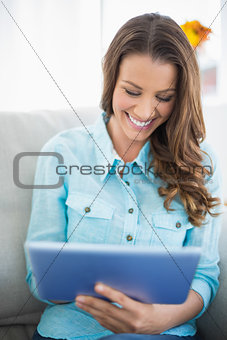 Laughing woman using tablet