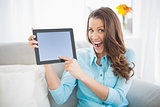 Euphoric woman showing her tablet screen