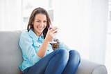 Smiling gorgeous woman holding glass of red wine
