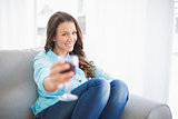 Smiling gorgeous woman offering glass of red wine