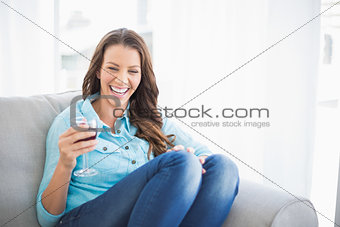 Radiant gorgeous woman holding glass of red wine