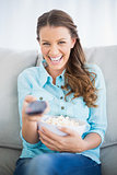 Happy woman watching television